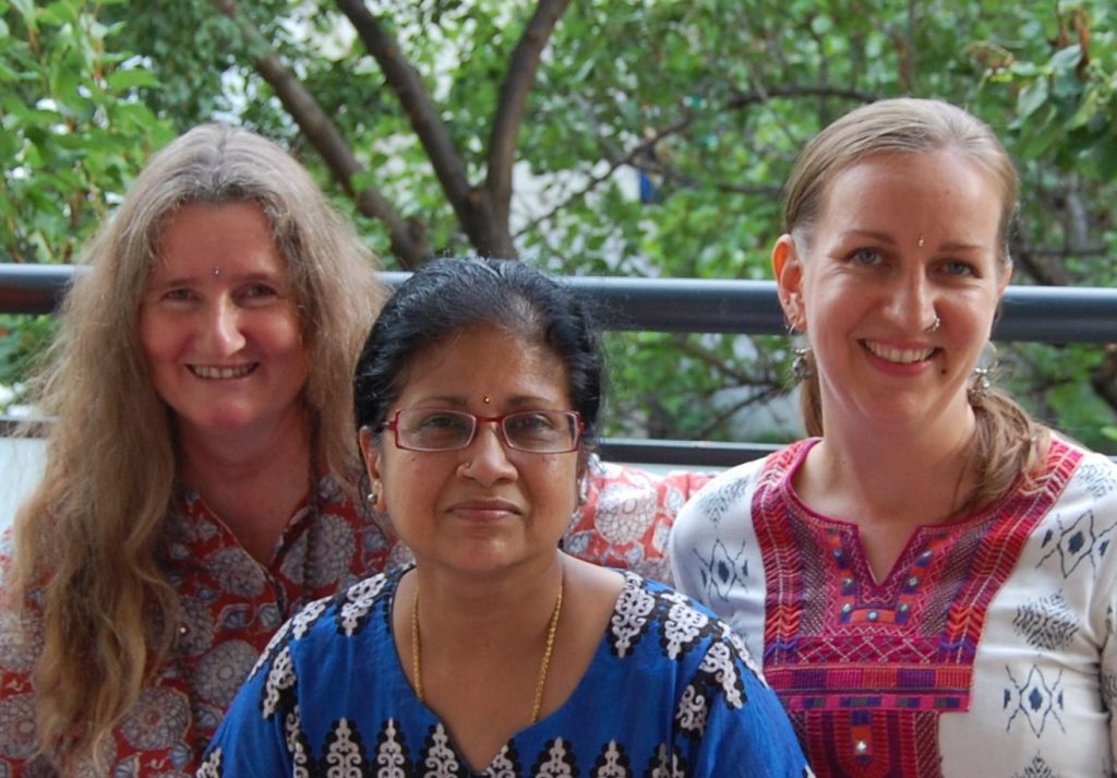 Karin Bindu, Sita Subramanian und Valerie Kleinschuster vor einem Baum.